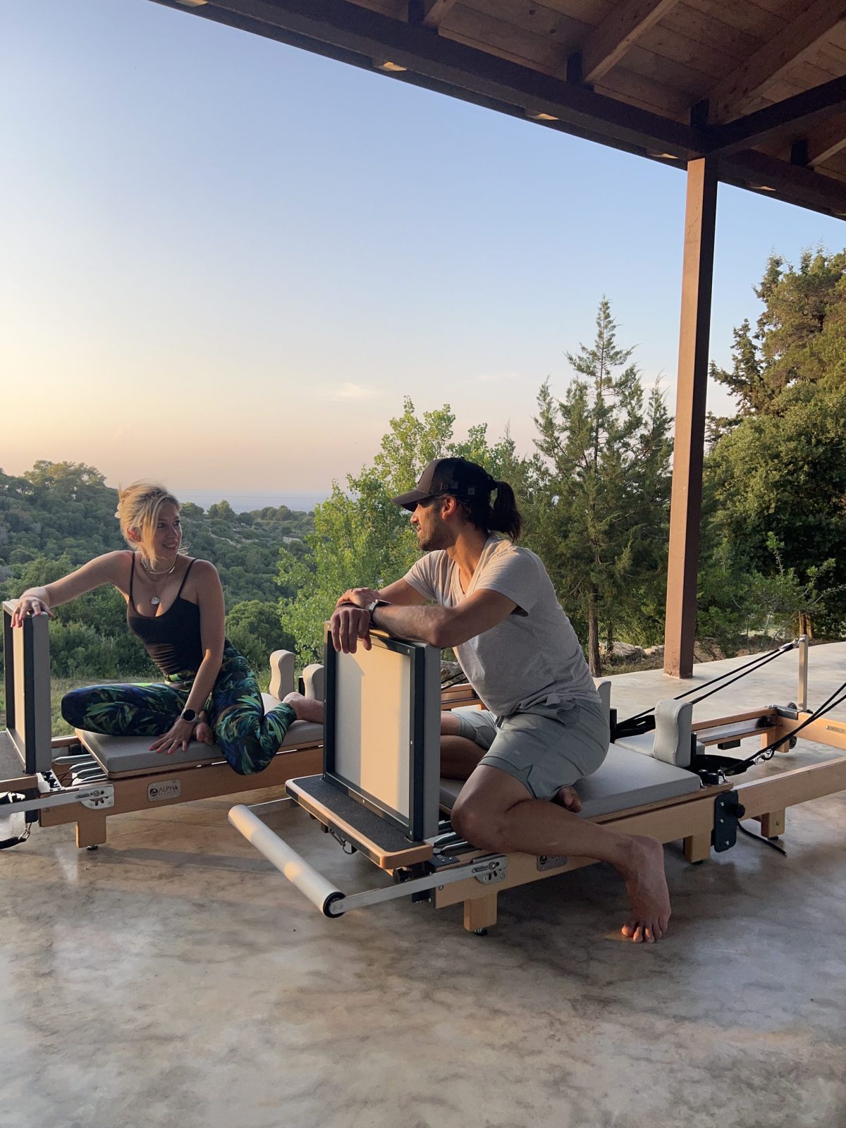 Couple training on reformers at an ANASA Elements retreat